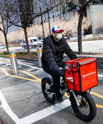 A man cycling on a bike, showcasing a dynamic outdoor activity in a vibrant setting. - Hausion