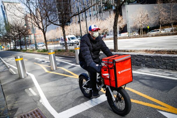 A man cycling on a bike, showcasing a dynamic outdoor activity in a vibrant setting. - Hausion