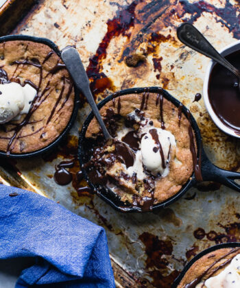 A tempting skillet of chocolate chip cookies, warm and gooey, inviting you to indulge in a sweet, comforting treat. - Hausion